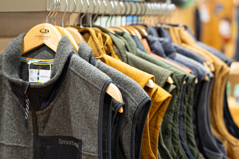 Smartwool vests hanging on a rack