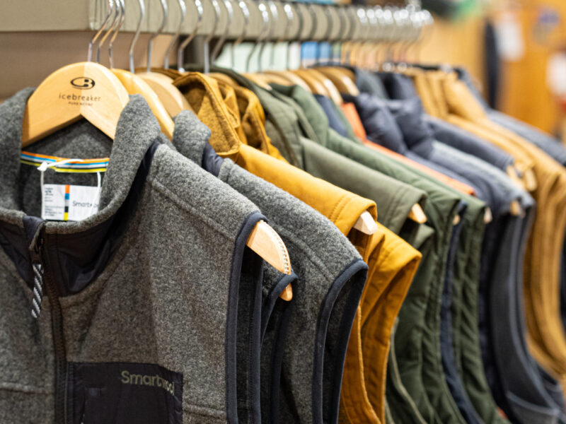 Smartwool vests hanging on a rack